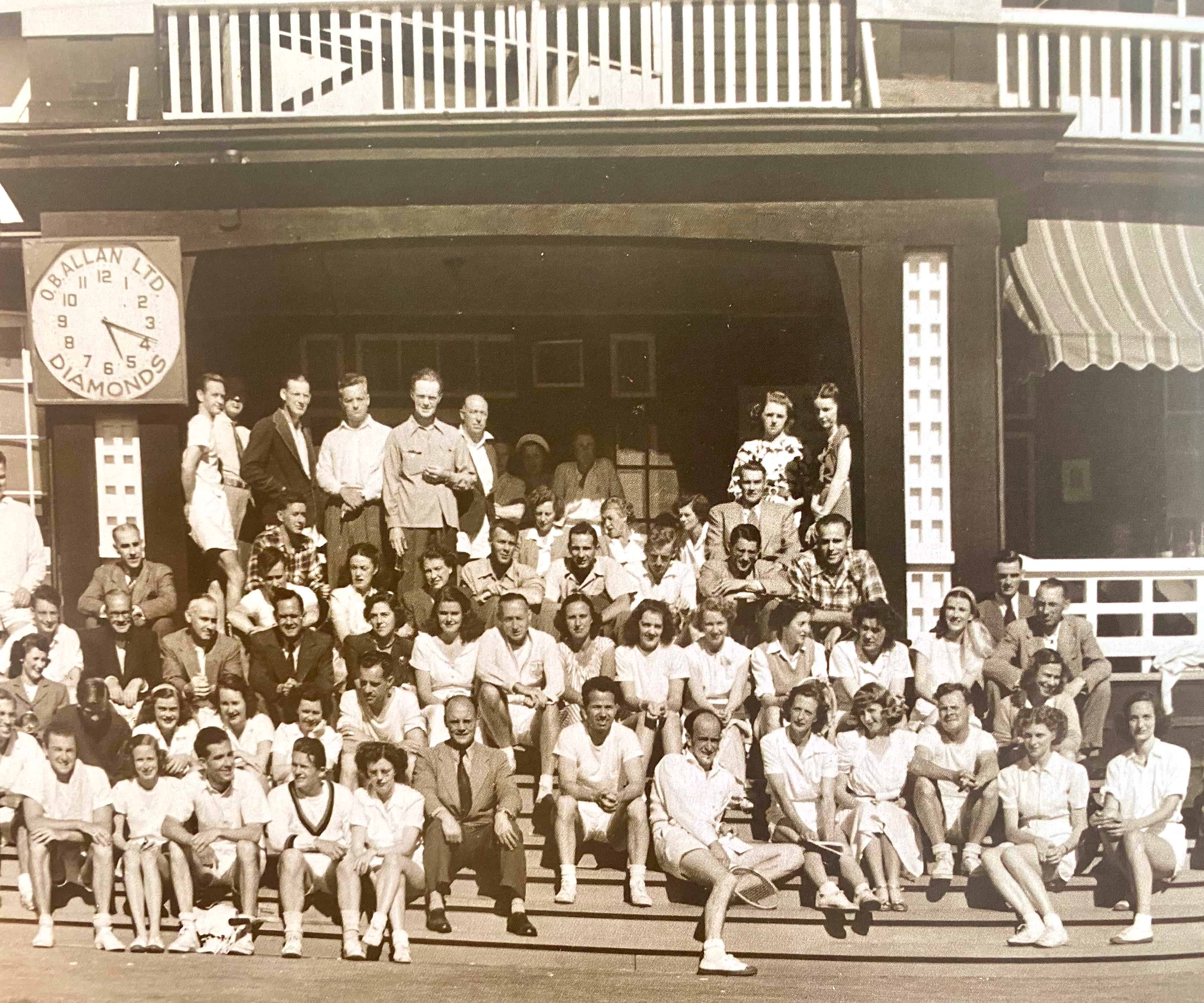Club Members pose on the steps of the McLure clubhouse on a summer evening
